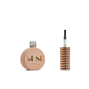 Nail-Bond A bottle of "MUSE" nail bond, with a matte pink finish and gold lettering on the bottle, next to its applicator brush with a clear handle adorned with shiny copper-colored rhinestones.